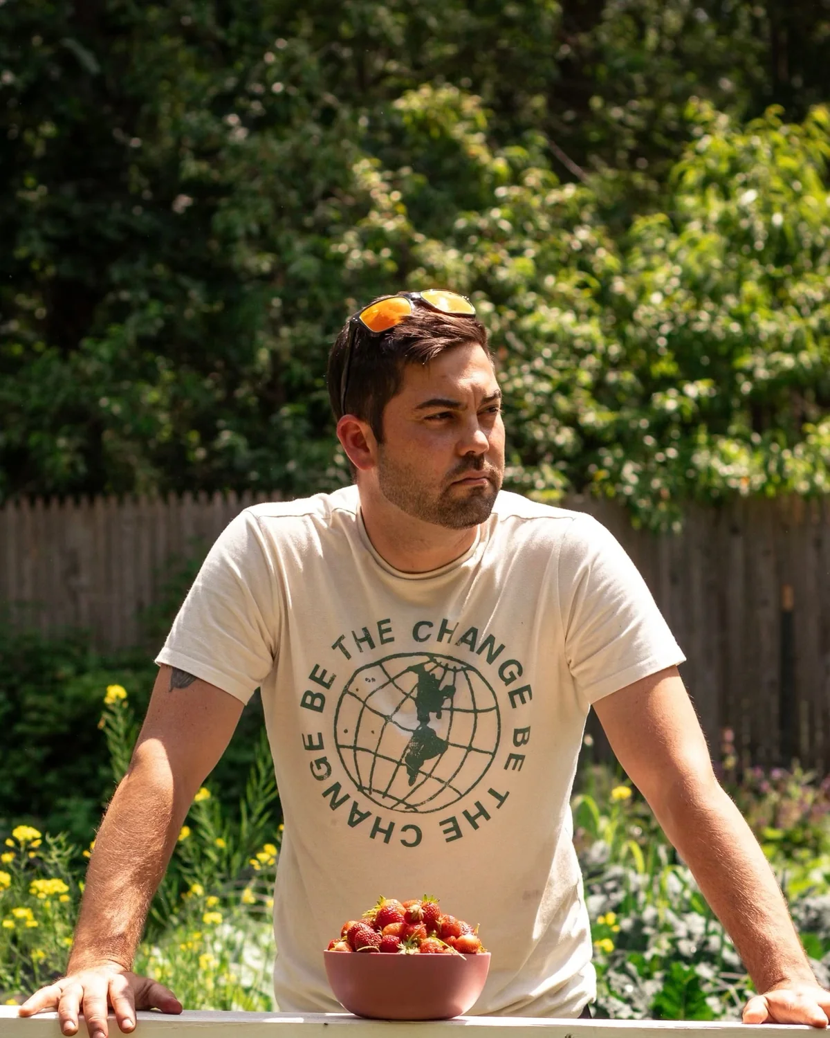 Standing in the garden with a bowl of strawberries